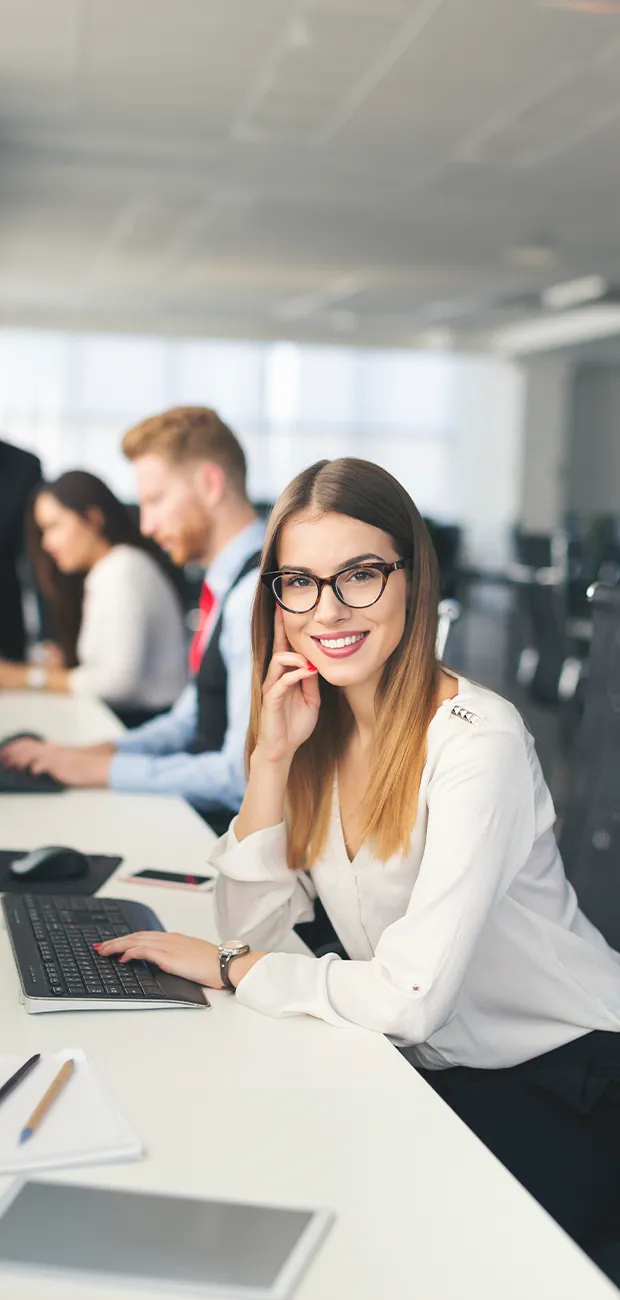 Smiling girl with glasses in a call center