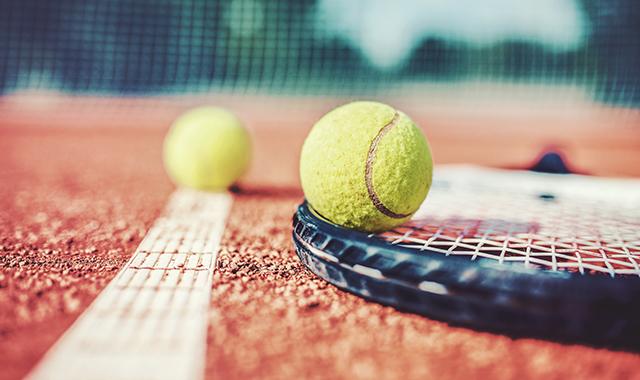 Tennis game. Tennis ball with racket on the tennis court. Sport, recreation concept